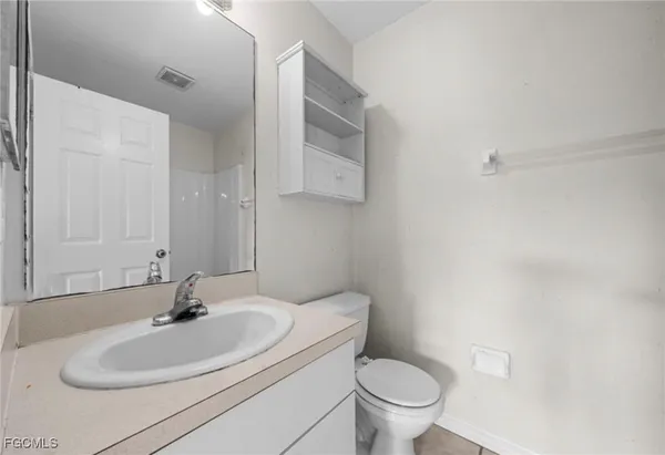 a bathroom with a sink toilet and a mirror