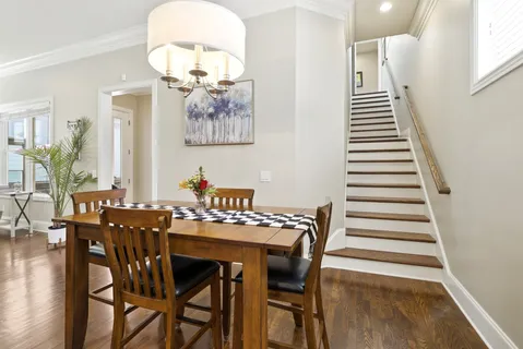 a view of a dining room with furniture and wooden floor