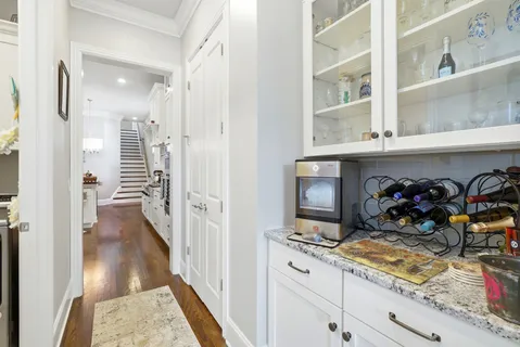a view of a hallway with wooden floor and a fireplace