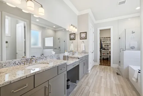 a spacious bathroom with a double vanity sink and a mirror