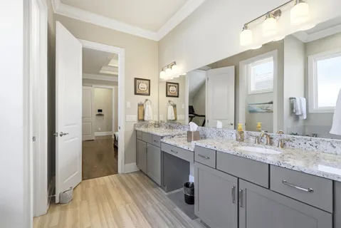 a bathroom with a double vanity sink and mirror
