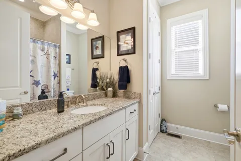 a bathroom with a sink double vanity granite and a mirror