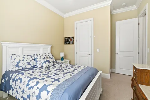 a bedroom with a large bed and a closet