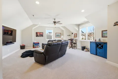 a living room with furniture a chandelier and a flat screen tv