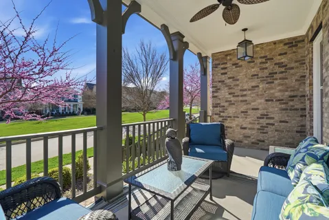 a balcony with wooden floor and outdoor seating