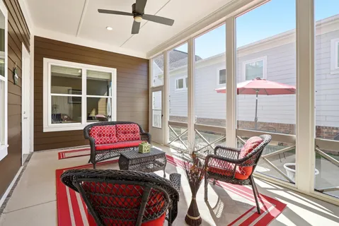 a living room with furniture a floor to ceiling window and a table