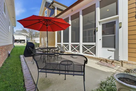 a view of a patio with chairs and umbrellas
