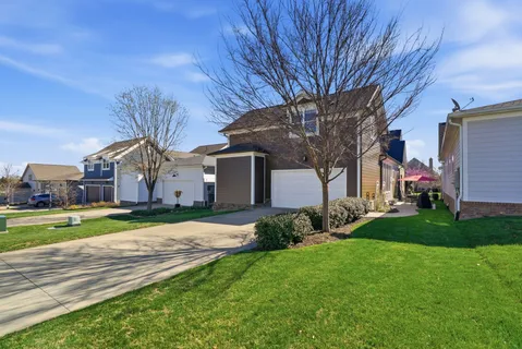 a house view with a sitting space and garden