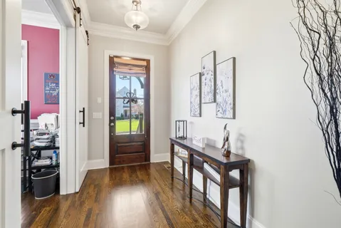 a bedroom with a bed and a wooden floor