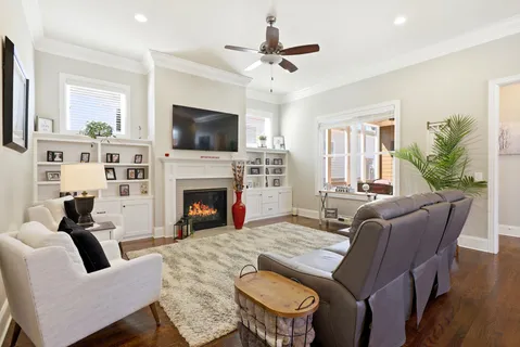a living room with furniture a flat screen tv and a fireplace
