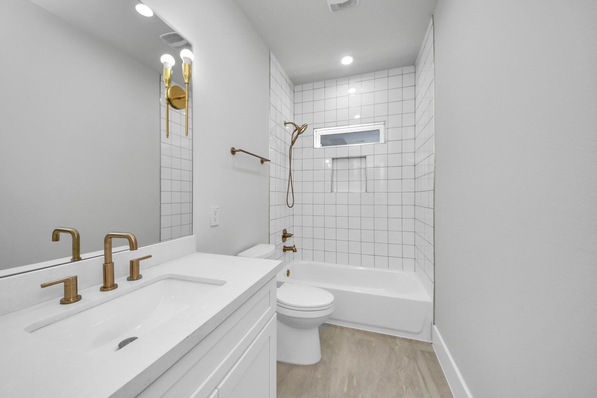 6320 Milwee Street, Unit B Houston, TX 77092 - Photo 15 of 30 a bathroom with a bathtub shower sink mirror and toilet
