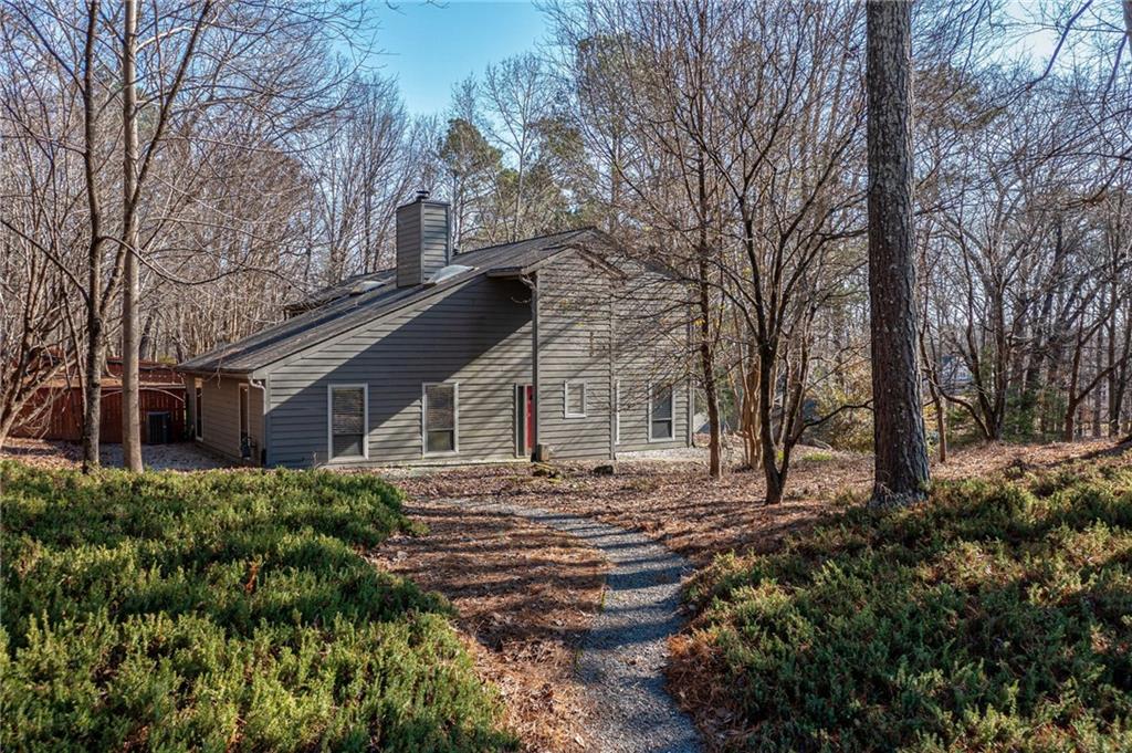 9040 Martin Road Roswell, GA 30076 - Photo 1 of 1 a view of a house with a yard