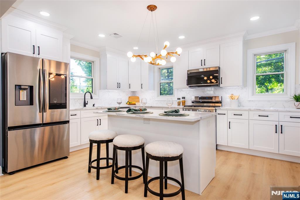 145 Grove Street Mahwah, NJ 07430 - Photo 6 of 30 a kitchen with stainless steel appliances a stove refrigerator sink and microwave