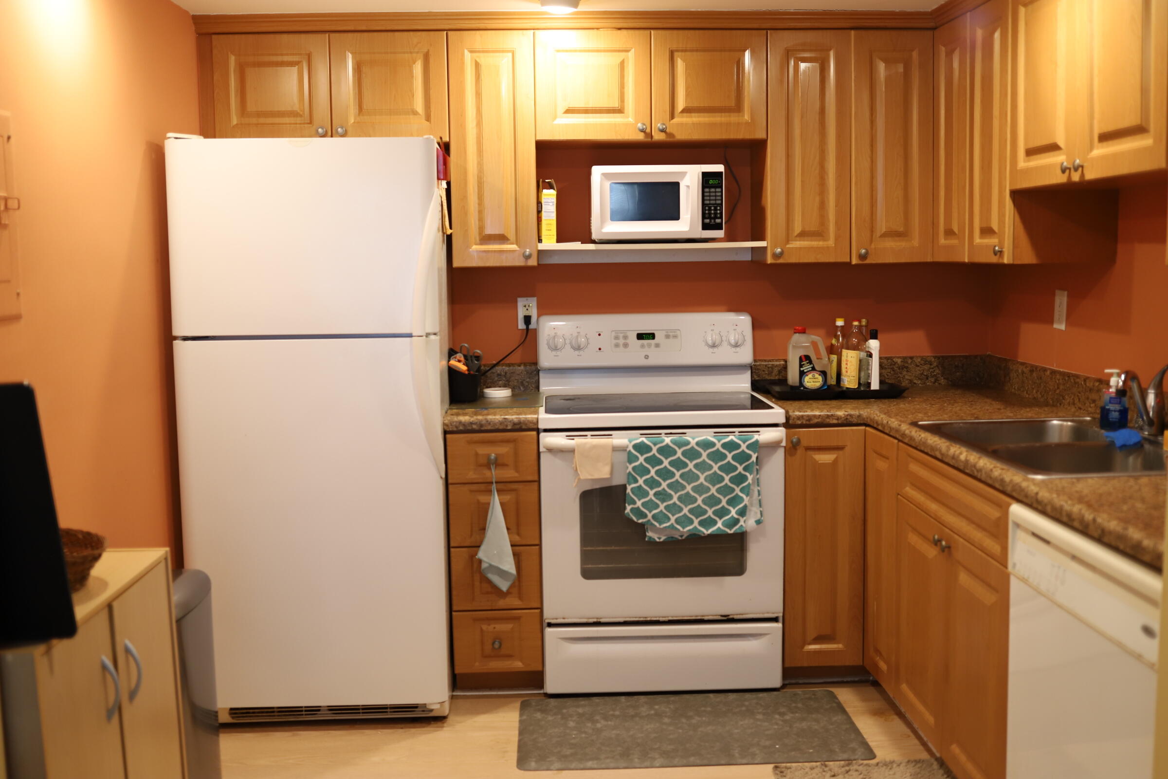 a kitchen with a refrigerator and a stove