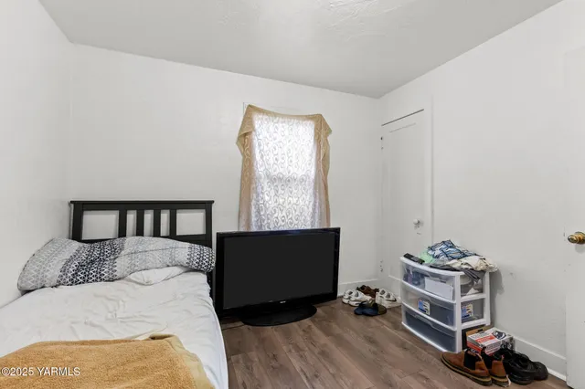 a bedroom with a bed and a potted plant