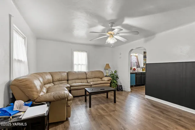 a living room with furniture and wooden floor
