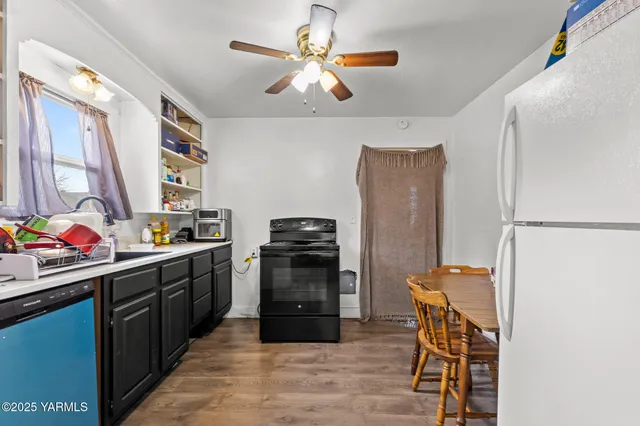 a kitchen with stainless steel appliances a stove refrigerator and a window