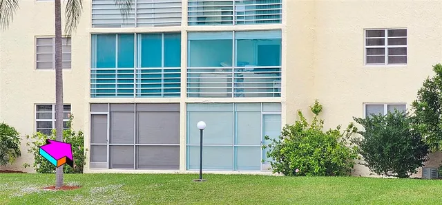 a front view of building with yard