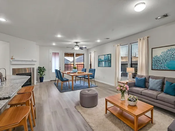 a living room with furniture and a fireplace