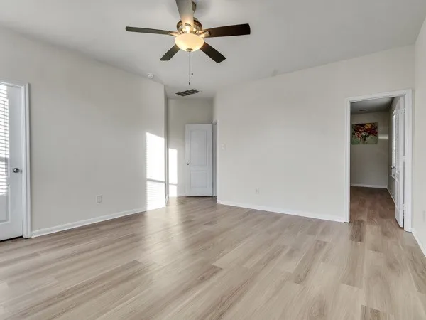 a spacious bathroom with a tub sink and mirror