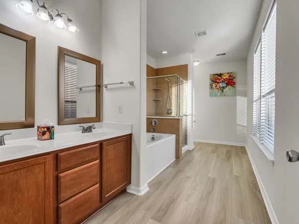 a bathroom with a bathtub and a shower