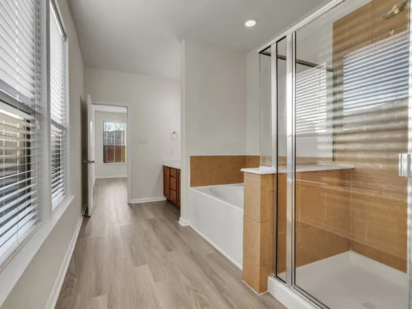 a view of a backyard with wooden fence and large trees