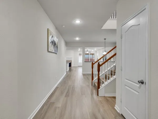 a view of entryway and hall with wooden floor