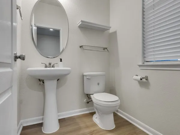 a bathroom with a sink toilet and a mirror