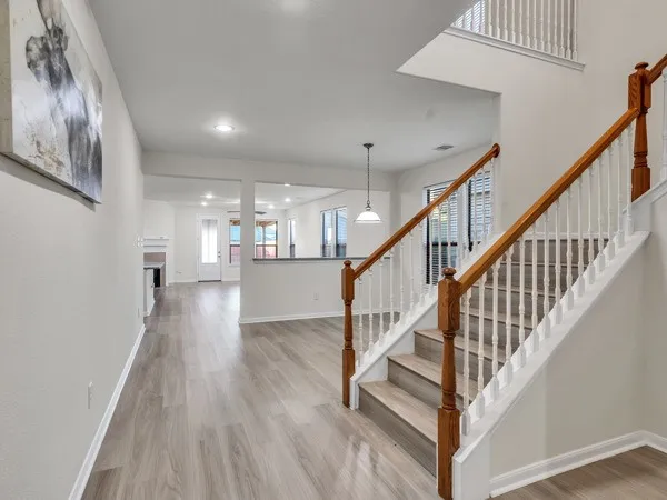 a view of staircase with wooden floor and a rug