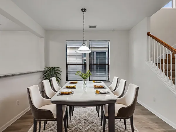 a view of a dining room with furniture window and wooden floor