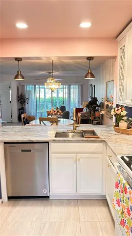 a kitchen with sink refrigerator and microwave