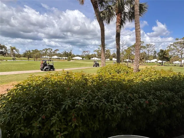 a view of a lake with houses in back