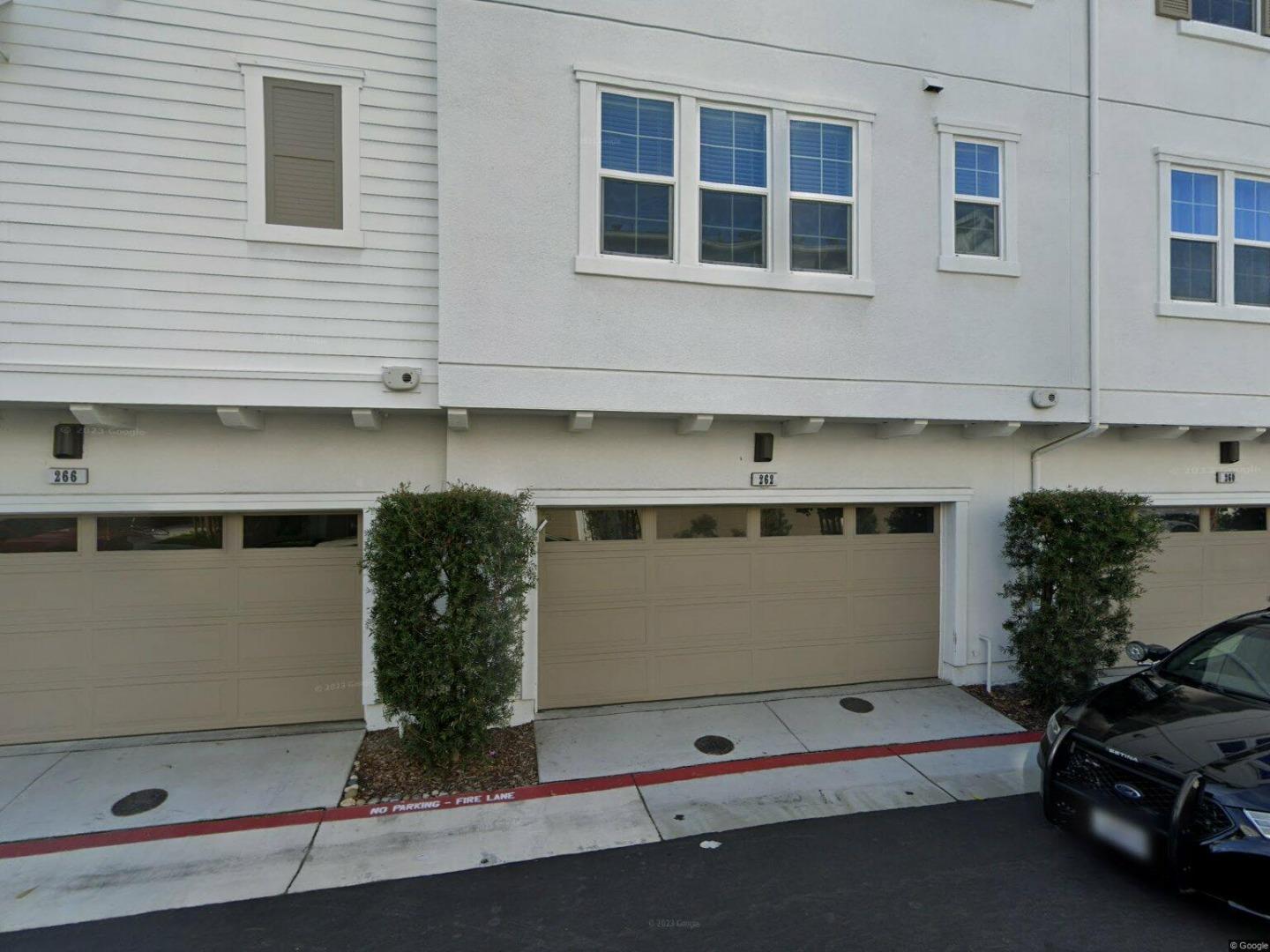 a view of building with car parked