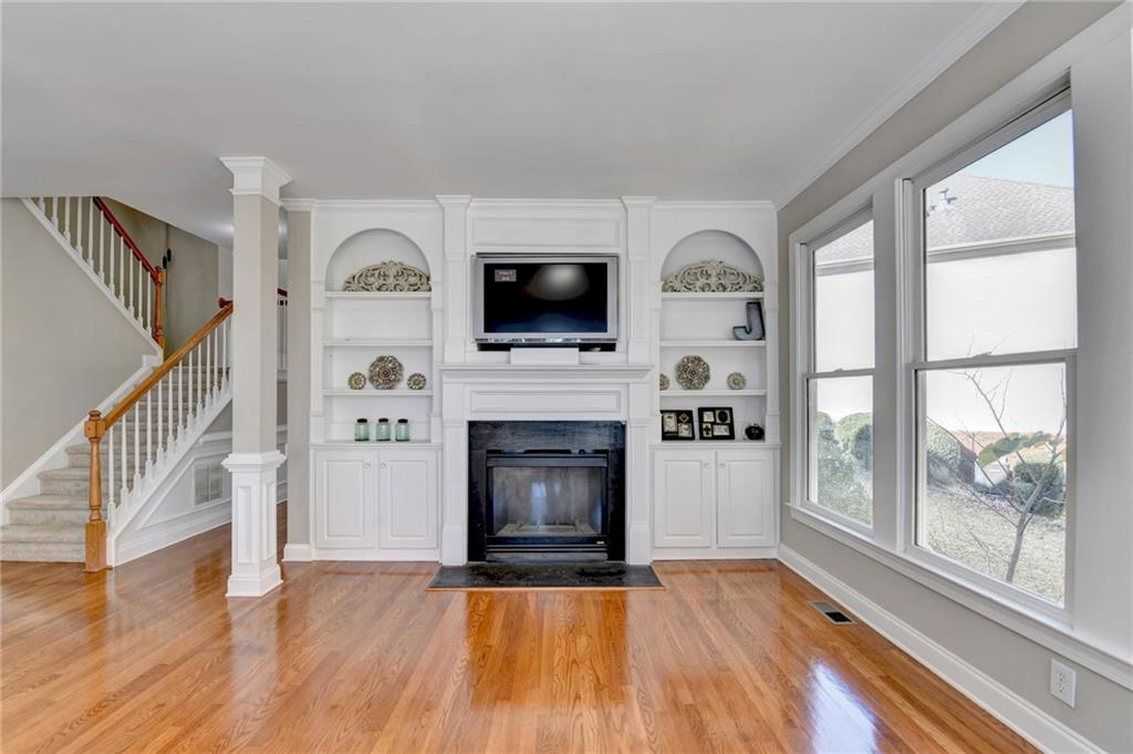 1601 Woodbow Crossing Dacula, GA 30019 - Photo 12 of 51 a living room with a fireplace and a flat screen tv
