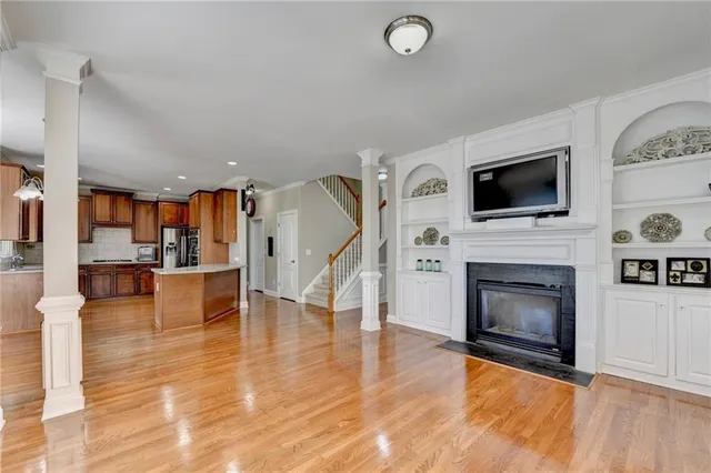 a living room with furniture a fireplace and a flat screen tv