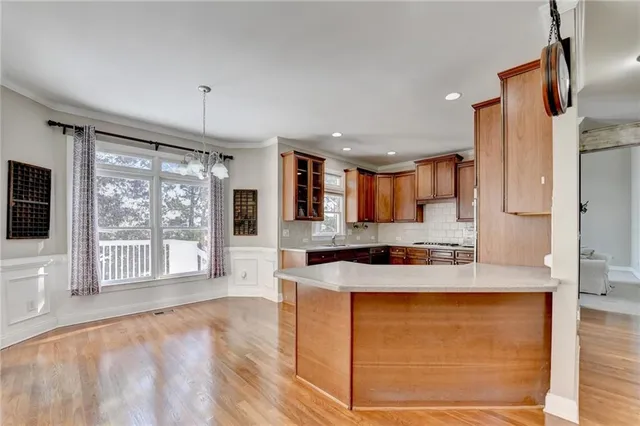 a kitchen with stainless steel appliances granite countertop a sink a stove and a refrigerator