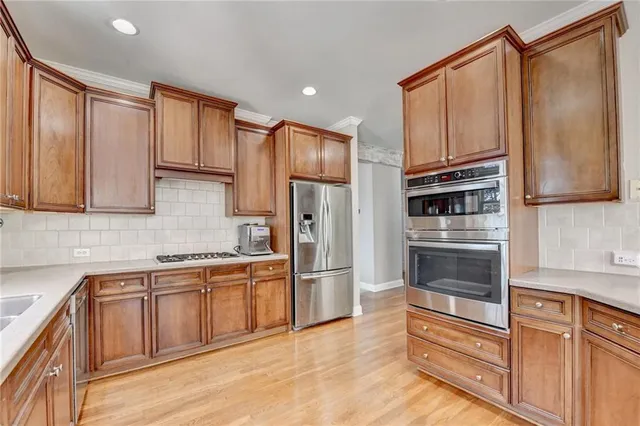 a kitchen with granite countertop stainless steel appliances and cabinets