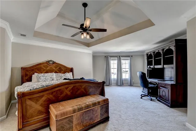 a bedroom with a bed window and a flat screen tv