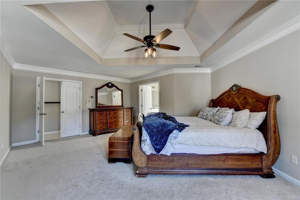 1601 Woodbow Crossing Dacula, GA 30019 - Photo 23 of 51 a bedroom with a bed and a chandelier