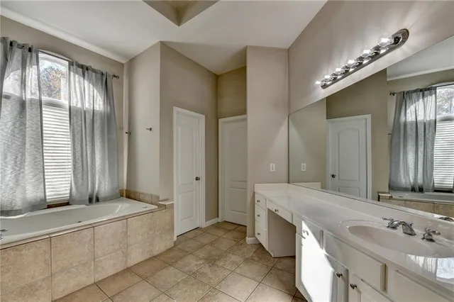 a spacious bathroom with a double vanity sink and a mirror
