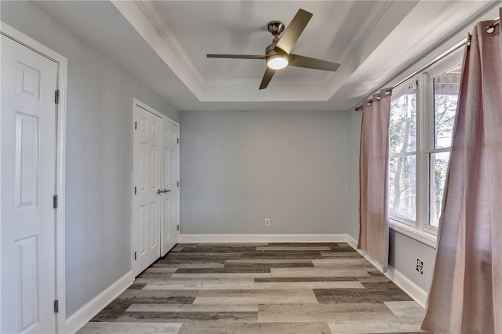 1601 Woodbow Crossing Dacula, GA 30019 - Photo 31 of 51 a view of an empty room with wooden floor and a window