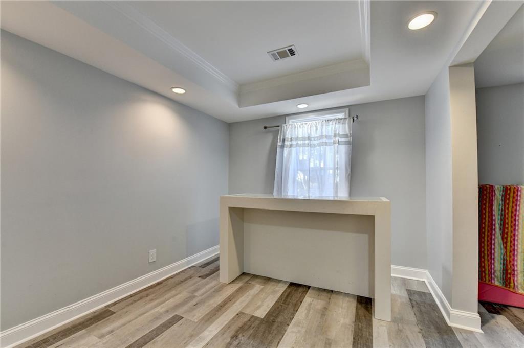 1601 Woodbow Crossing Dacula, GA 30019 - Photo 34 of 51 a view of an empty room with wooden floor and a window