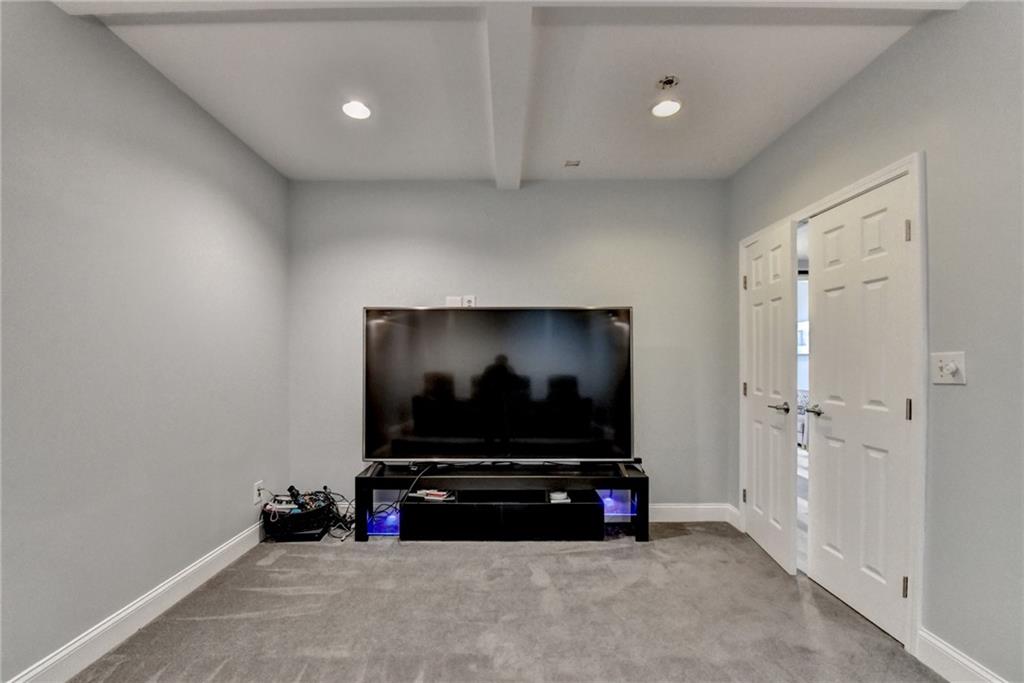 1601 Woodbow Crossing Dacula, GA 30019 - Photo 36 of 51 a living room with furniture and a flat screen tv