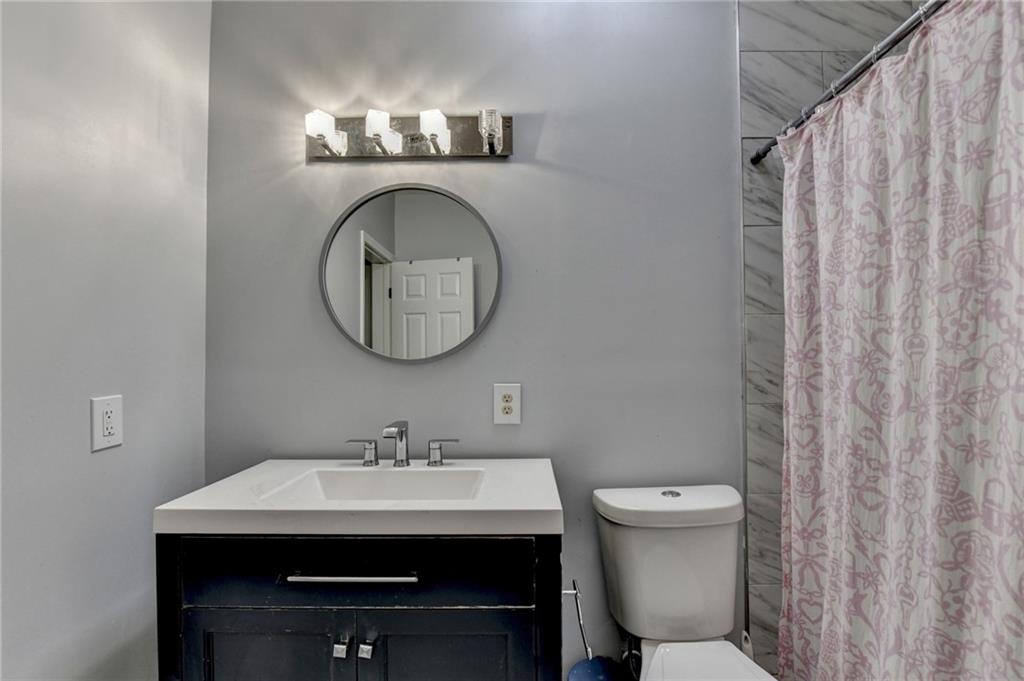 1601 Woodbow Crossing Dacula, GA 30019 - Photo 37 of 51 a bathroom with a sink and a mirror