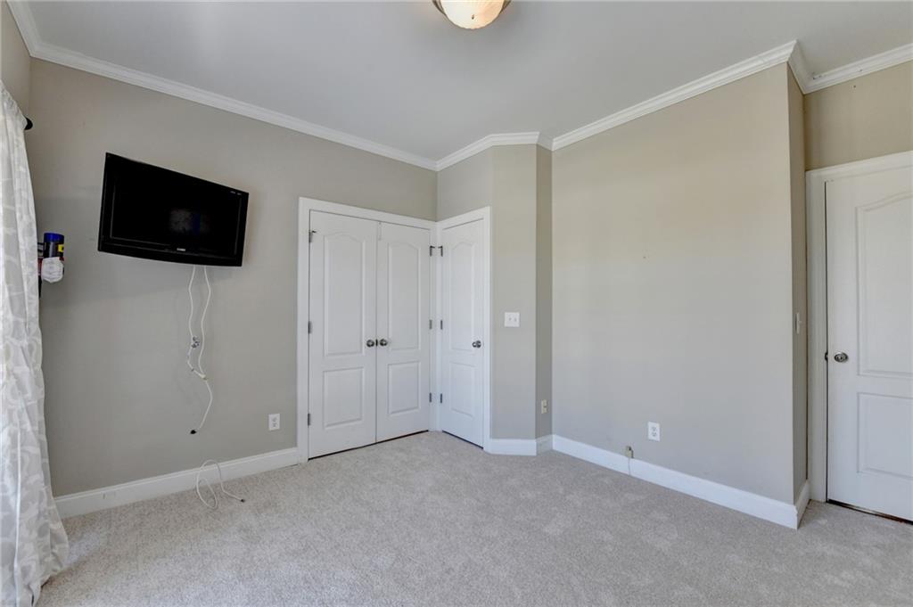 1601 Woodbow Crossing Dacula, GA 30019 - Photo 9 of 51 a view of an empty room with a flat screen tv and a window