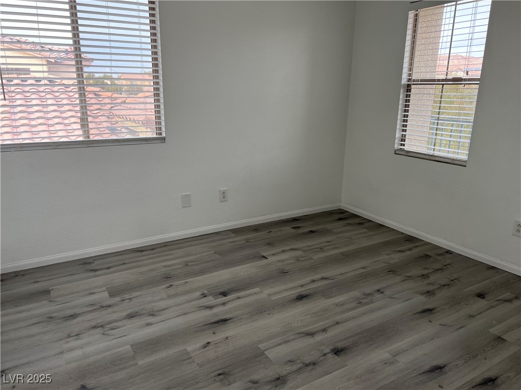 Undisclosed Address Las Vegas, NV 89142 - Photo 13 of 23 Spare room featuring wood finished floors and base