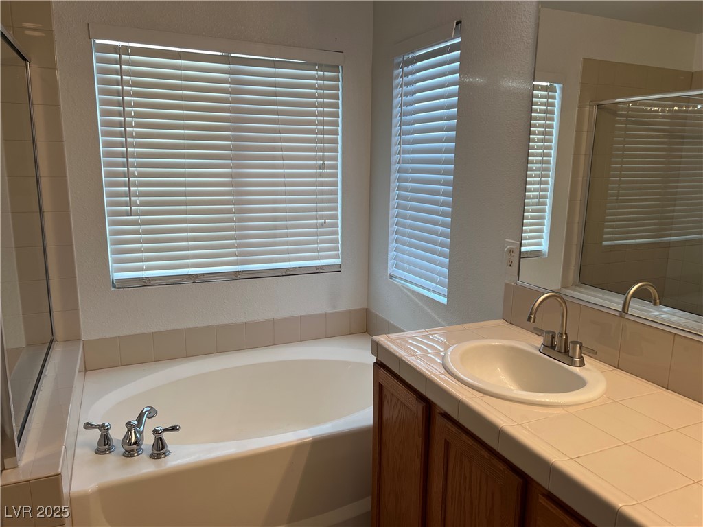 Undisclosed Address Las Vegas, NV 89142 - Photo 15 of 23 Full bathroom featuring vanity, a garden tub, and