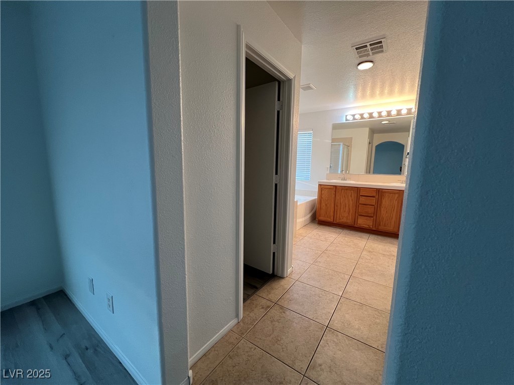Undisclosed Address Las Vegas, NV 89142 - Photo 18 of 23 Hall featuring visible vents, baseboards, light ti