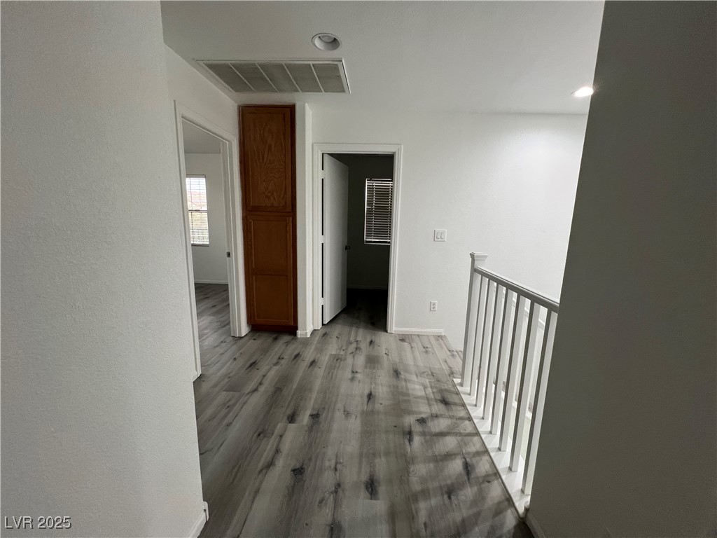 Undisclosed Address Las Vegas, NV 89142 - Photo 20 of 23 Corridor with visible vents, baseboards, and light