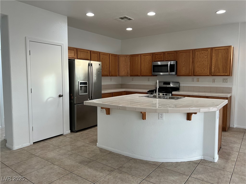 Undisclosed Address Las Vegas, NV 89142 - Photo 5 of 23 Kitchen with visible vents, a sink, tile counters,